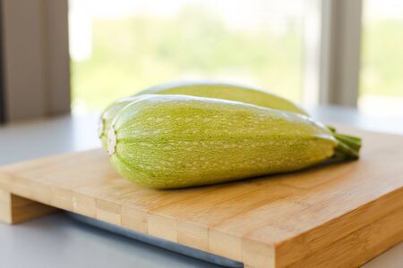 Fresh zucchini on wooden backgroundの写真素材