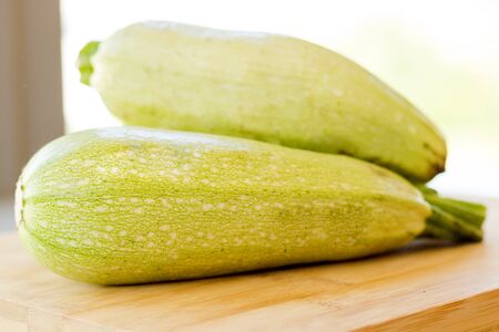 Fresh zucchini on wooden backgroundの写真素材