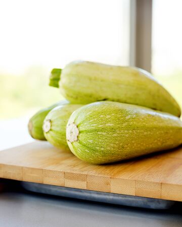 Fresh zucchini on wooden backgroundの写真素材