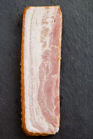 smoked bacon on kitchen tableの写真素材