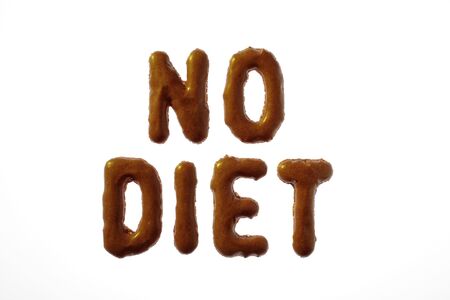 Letter cookies writing NO DIET on white backgroundの写真素材