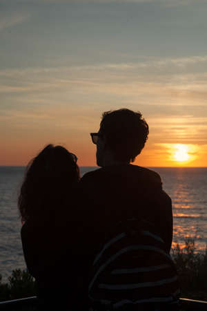 Lovely couple watching the sunset at Biarritzの写真素材