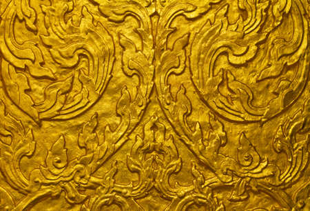 Buddha carved gold paint on temple doorの写真素材
