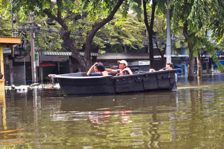 BANGKOK, THAILAND - OCTOBER 30 : People navigating the streets during the worst flooding in decades on October 30,2011  Bangkok, Thailand.のeditorial素材