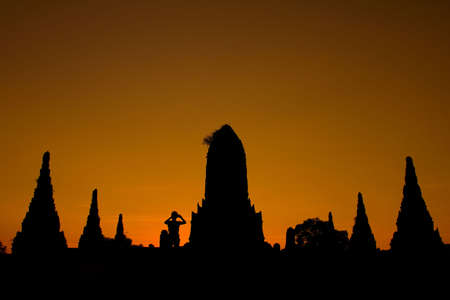 Silhouette of pagoda and man at Wat Chaiwattanaram Temple, Ayutthaya, Thailandの写真素材