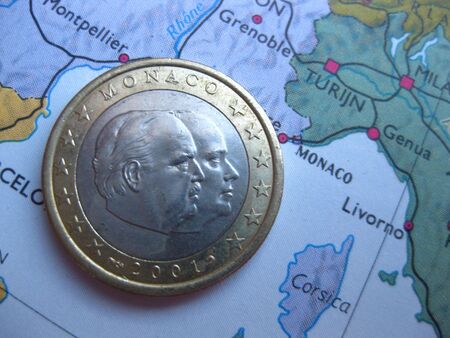 Monaco euro coin on vintage mapの写真素材