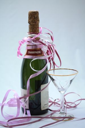 Champagne glass, bottle and decorative ribbonsの写真素材