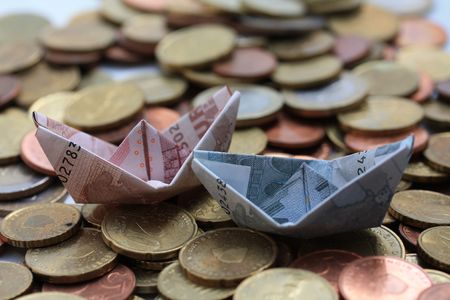 Euro boats sailing on a euro coin sea