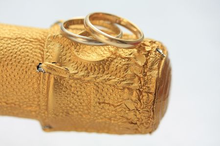 A set of two plain wedding bands on a bottle of champagneの写真素材