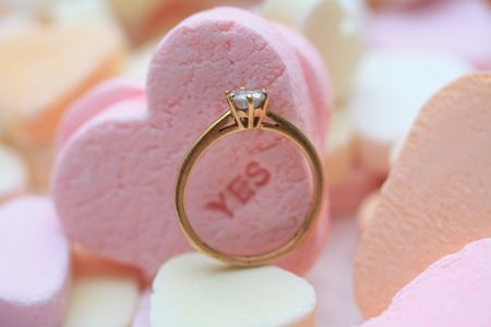 Solitaire diamond engagement ring on valentine candy heart with text ÿesの写真素材