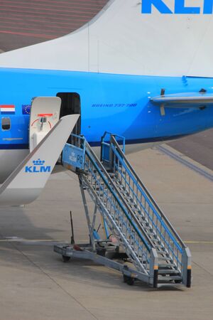 March, 24th, Amsterdam Schiphol Airport the Netherlands: airplane on the gate, rare exit detailのeditorial素材