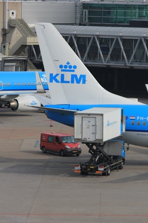 March, 24th, Amsterdam Schiphol Airport the Netherlands: loading baggage to an airplaneのeditorial素材