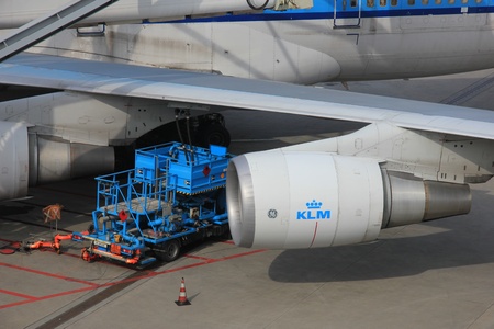 March, 24th, Amsterdam Schiphol Airport, an airplane gets its fuel from an underground fueling systemのeditorial素材