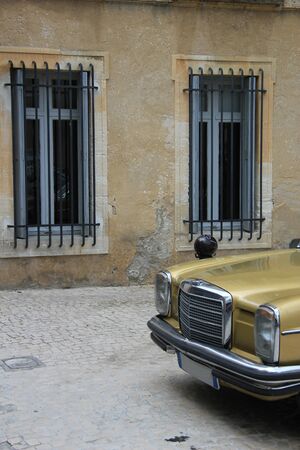 Vintage car in front of old building