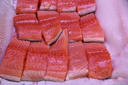 Wild salmon filets on ice in a fish shopの写真素材