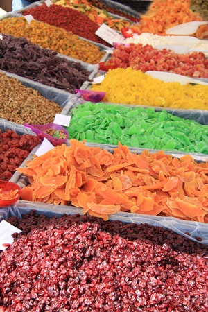 Candied fruits in various colors at a market stallの写真素材