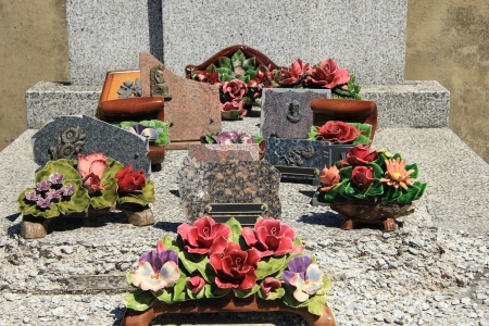 Ceramic grave flowers at a thombstone in Franceの写真素材