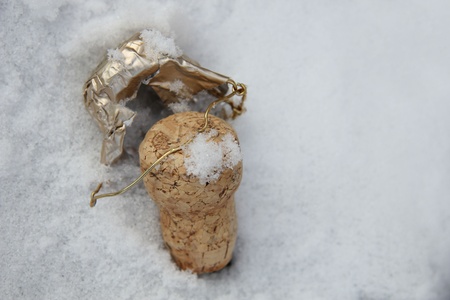 Champagne cork in fresh fallen snow, close upの写真素材