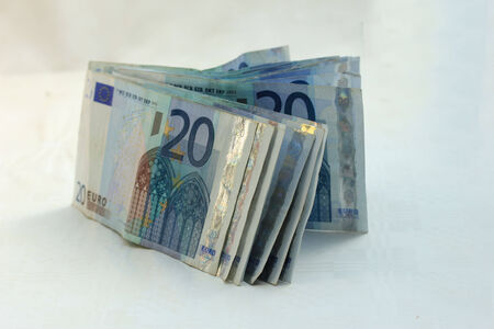stacked 20 euro banknotes on white background