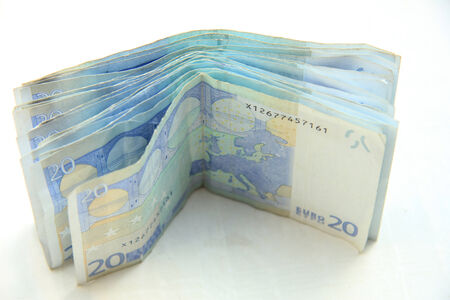 stacked 20 euro banknotes on white background
