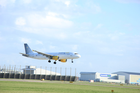 Schiphol Amsterdam, The Netherlands, march 31, 2015: EC-HQI Vueling Airbus A320-214  approaching on runway 09/27 Buitenveldertのeditorial素材