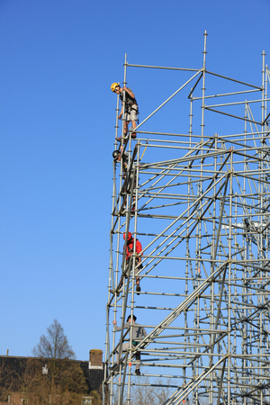 Construction workers setting up a new scaffoldingの写真素材