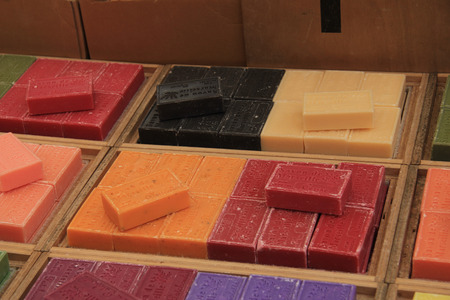 Soap from the Provence in various colors at a market stallの写真素材