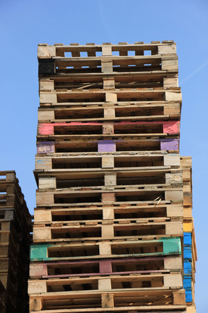 Stacked wooden pallets at a pallet storageの写真素材
