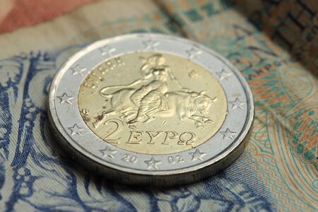 Greek euro coin on a vintage greek bank note