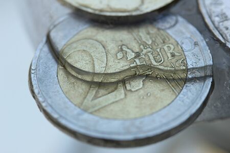 Two Euro coin in ice, frozen assetsの写真素材
