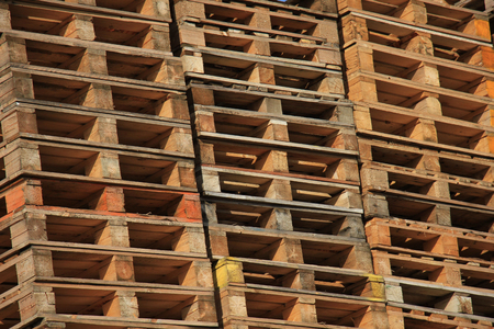 Stacked wooden pallets at a storage