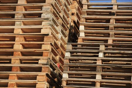 Stacked wooden pallets at a storageの写真素材