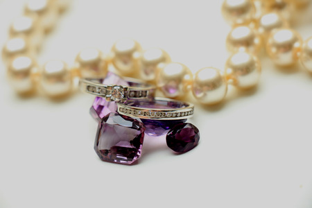 Diamond rings on loose purple amethyst gemstonesの写真素材