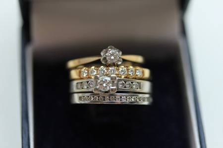 Two wedding sets, one in yellow gold, one in white gold for a double bride weddingの写真素材