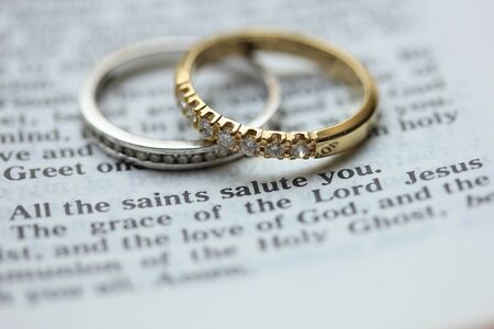 Two diamond wedding bands for a double bride wedding, on a bible verse