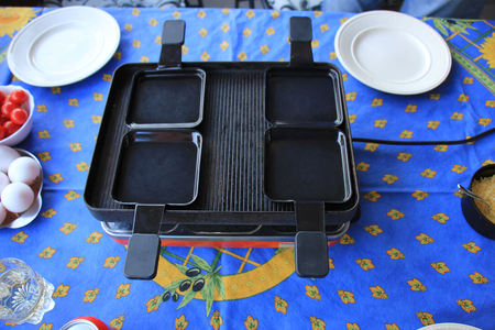 Raclette set, electric barbecue to use on the tableの写真素材