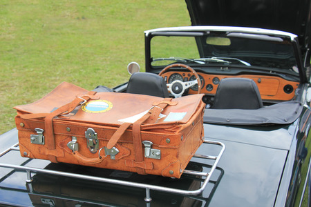 Vintage leather suitcase on a luggage rack
