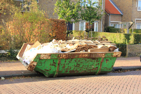 Loaded dumpster near a construction site, home renovation