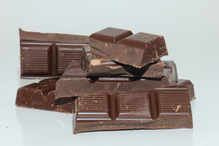 Dark chocolate bar , broken in oneven pieces