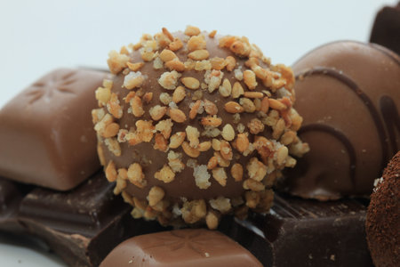Different sorts of chocolates: bonbons and broken pieces of a chocolate bar