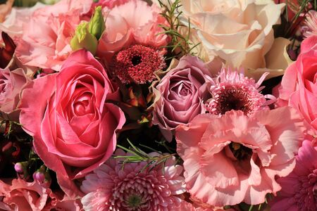 Mixed flowers in different shades of pink in a floral wedding decorationの写真素材