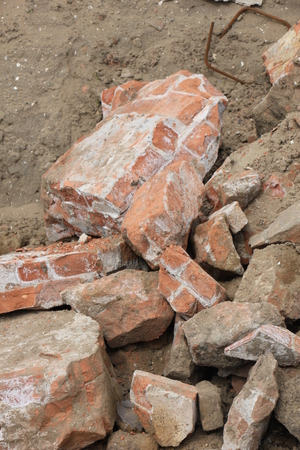 Pile of broken red bricks on construction siteの写真素材