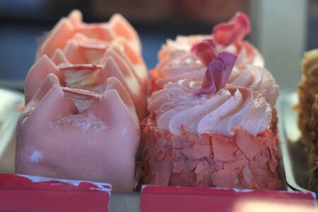 Fresh made pink cakes in a shop displayの写真素材