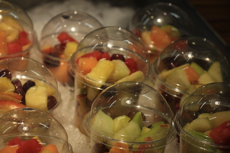 Fresh fruit on ice at a self service restaurantの写真素材