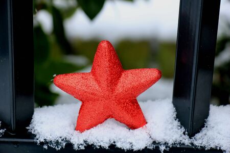 Red star ornament in fresh fallen snow