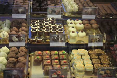 Luxurious Chocolates on display in a confectioner's shop (tags: price and product information in Dutch)のeditorial素材