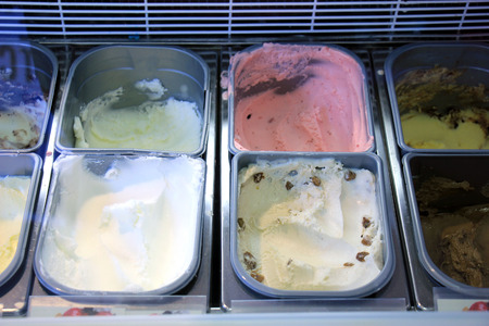 Assorted ice cream flavours on display in an ice cream parlourの写真素材