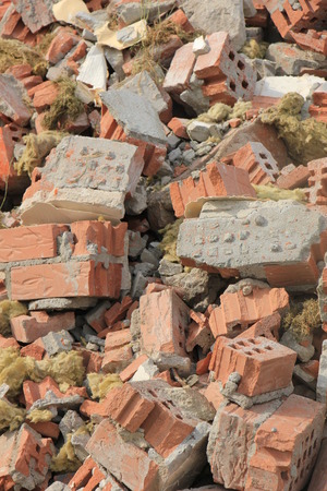 Pile of broken red bricks on construction siteの写真素材