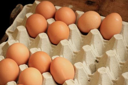 Fresh eggs in a carton box on a market stall
