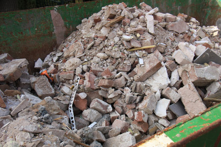 Broken bricks in a dumpster on a construction site